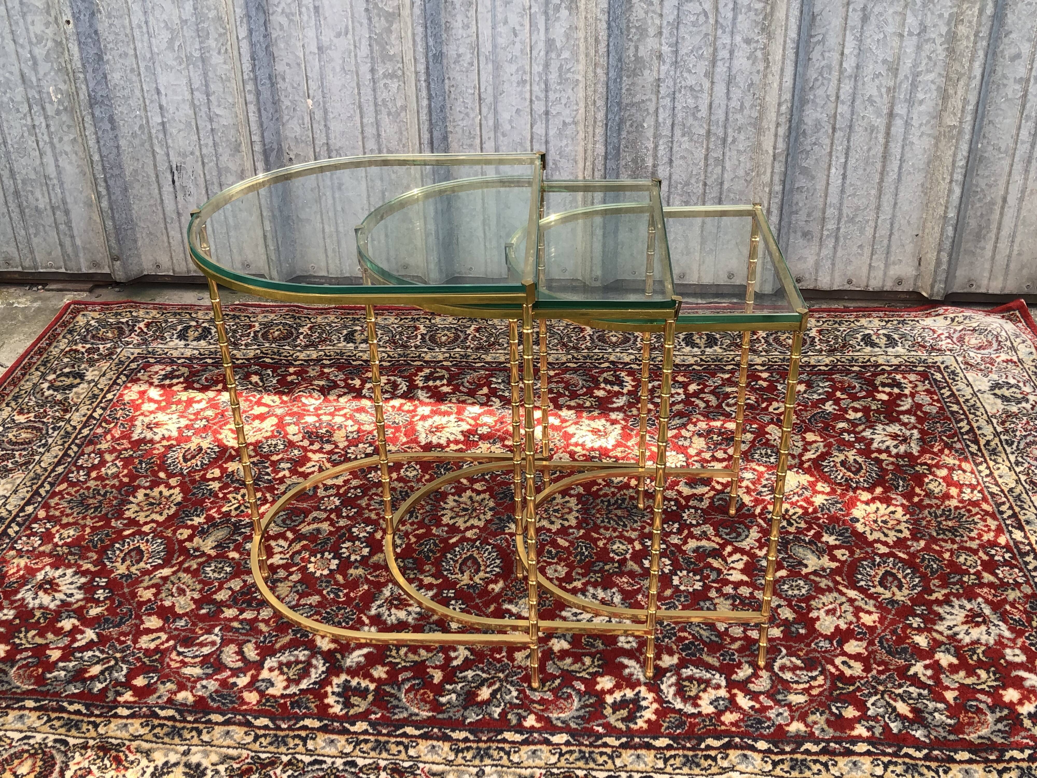 Suite of 3 trundle tables in golden brinze and glass slabs period 1970/1980