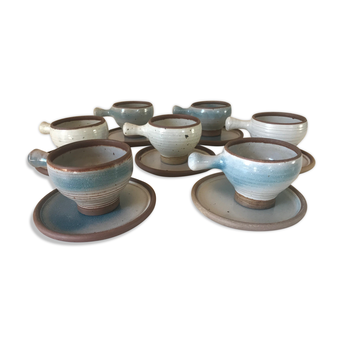Lot 7 cups and saucers sandstone by Roger Jacques