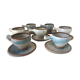 Lot 7 cups and saucers sandstone by Roger Jacques