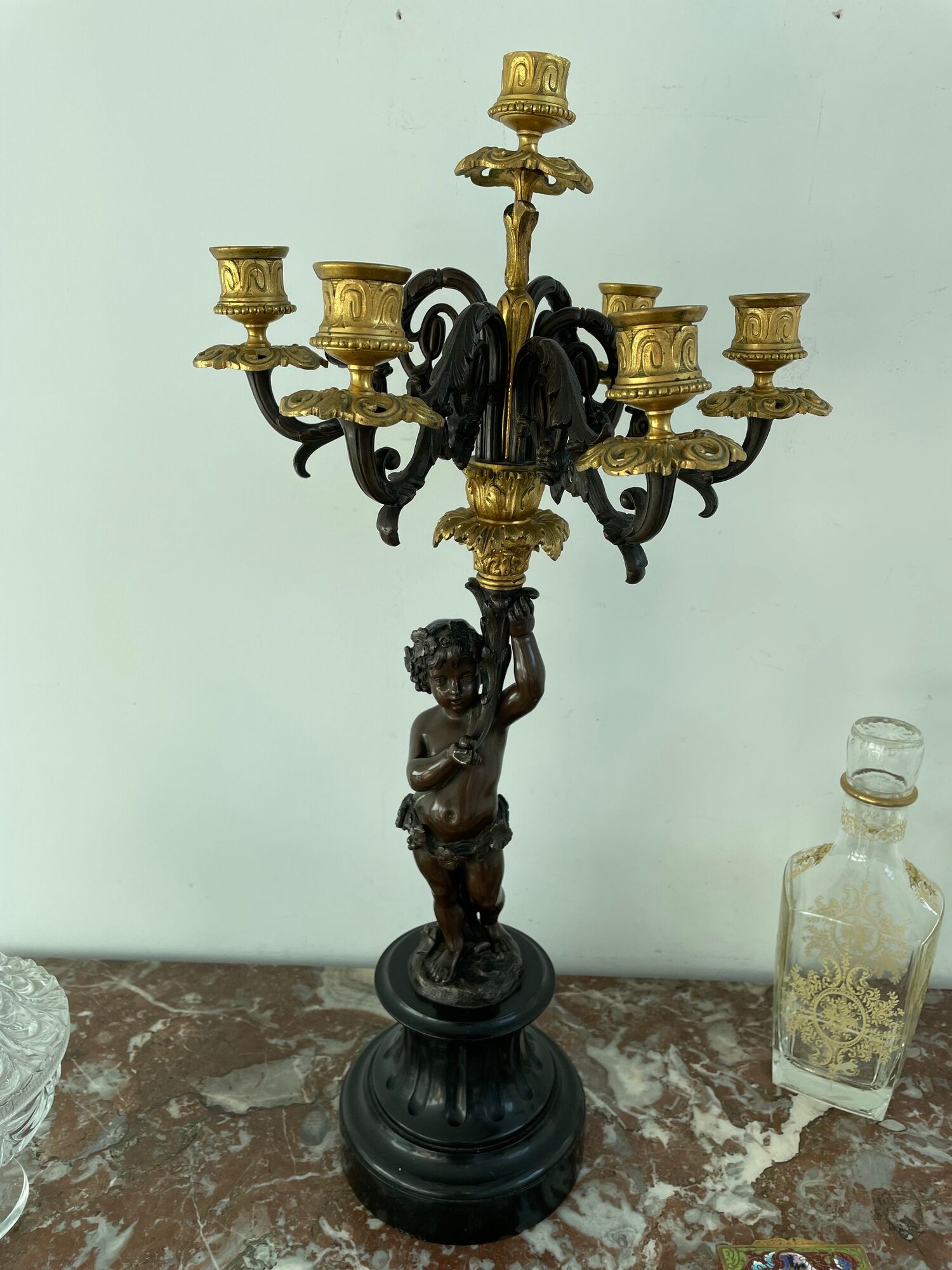 Candelabra with cherub in patinated bronze