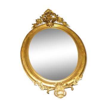 Ovoid mirror with double gilt pediments, circa 1830, 105x66 cm