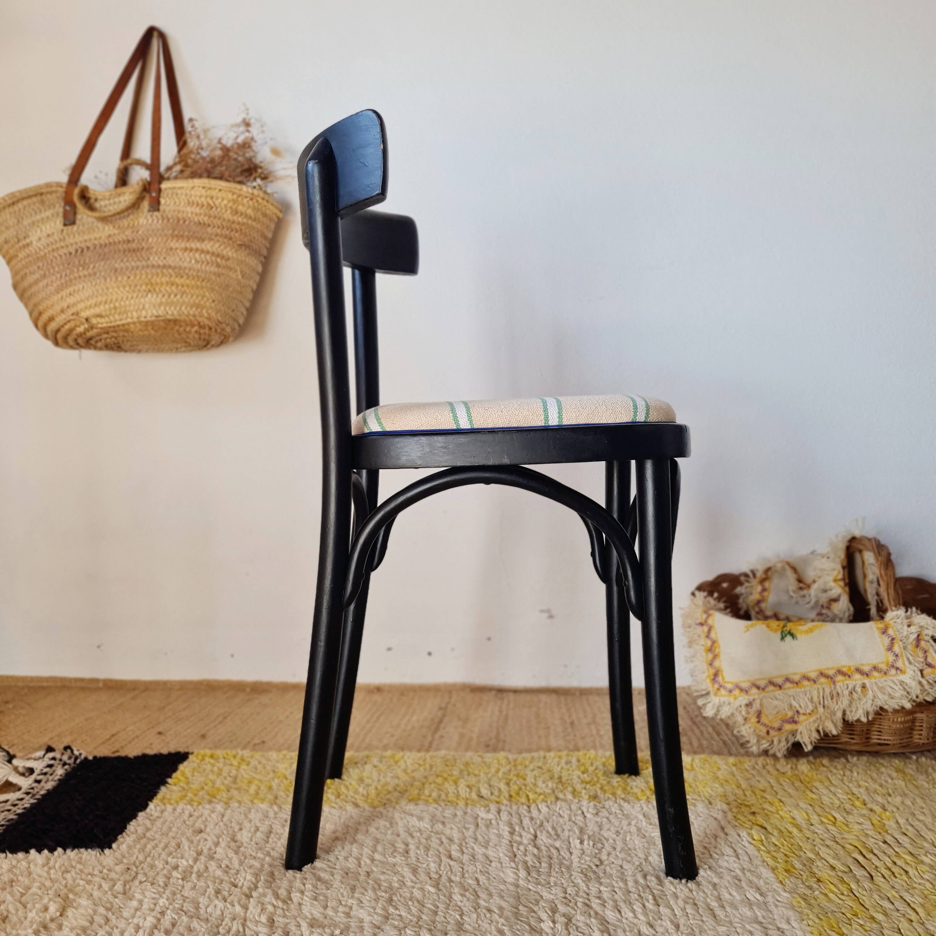 Curved black wooden bistro chair with striped seat