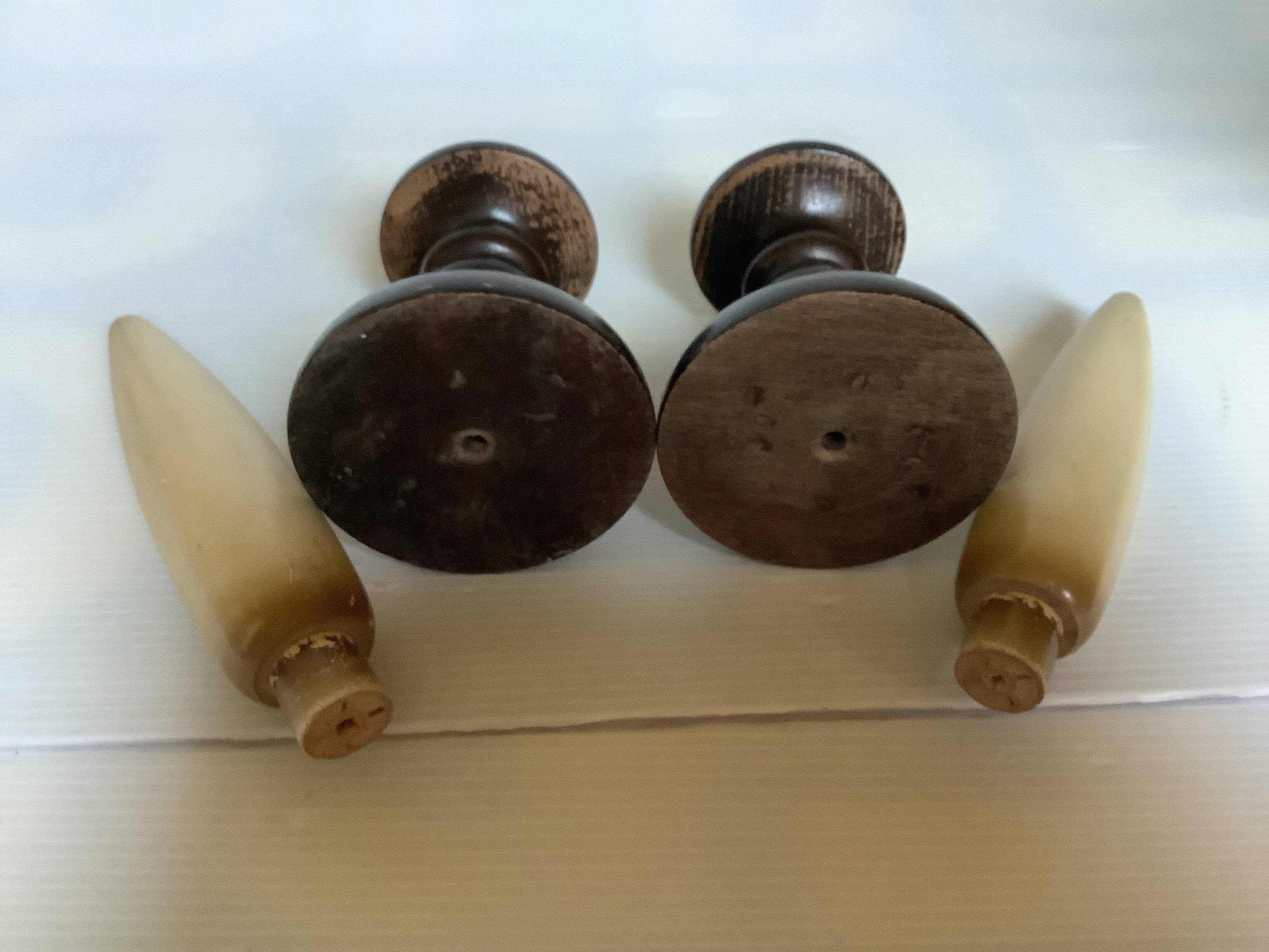 Pair of wooden candlesticks with fake wooden candles.