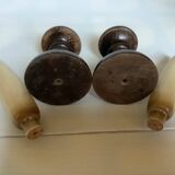 Pair of wooden candlesticks with fake wooden candles.