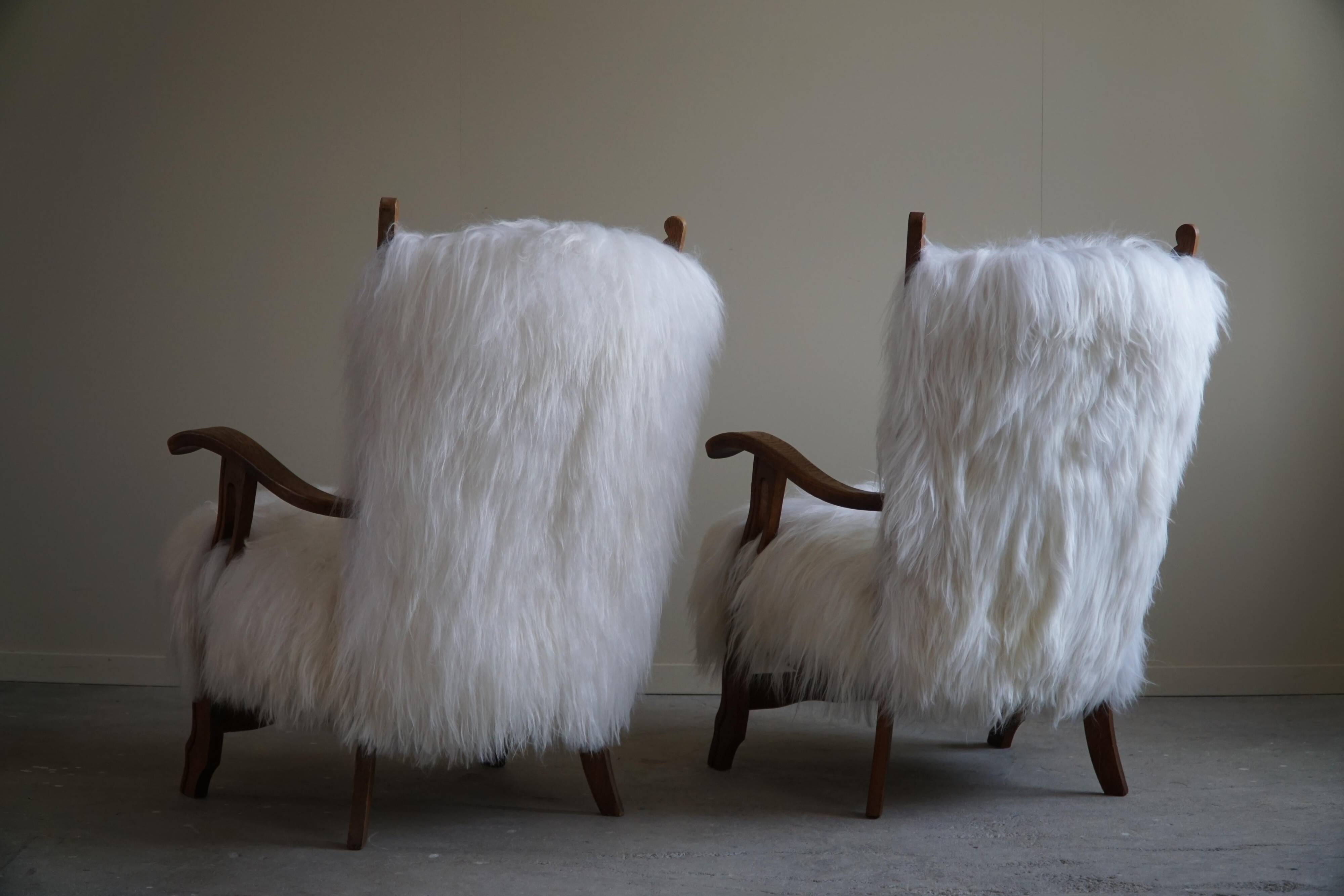 Pair of Scandinavian armchairs in oak and long-haired Icelandic sheepskin by Henning Kjærnulf, 1950.