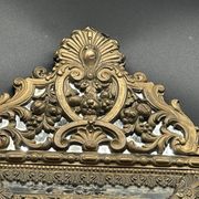 Small mirror with brass parcloses in repoussé style Louis XIV, late 19th century.