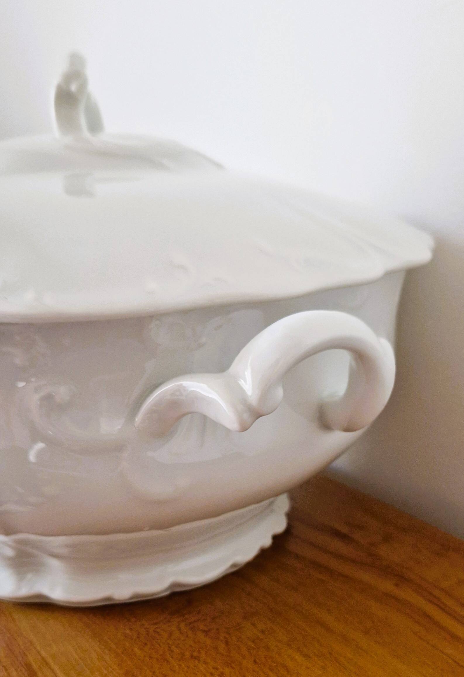 White porcelain soup tureen from Limoges with a vegetal scroll design.
