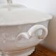 White porcelain soup tureen from Limoges with a vegetal scroll design.