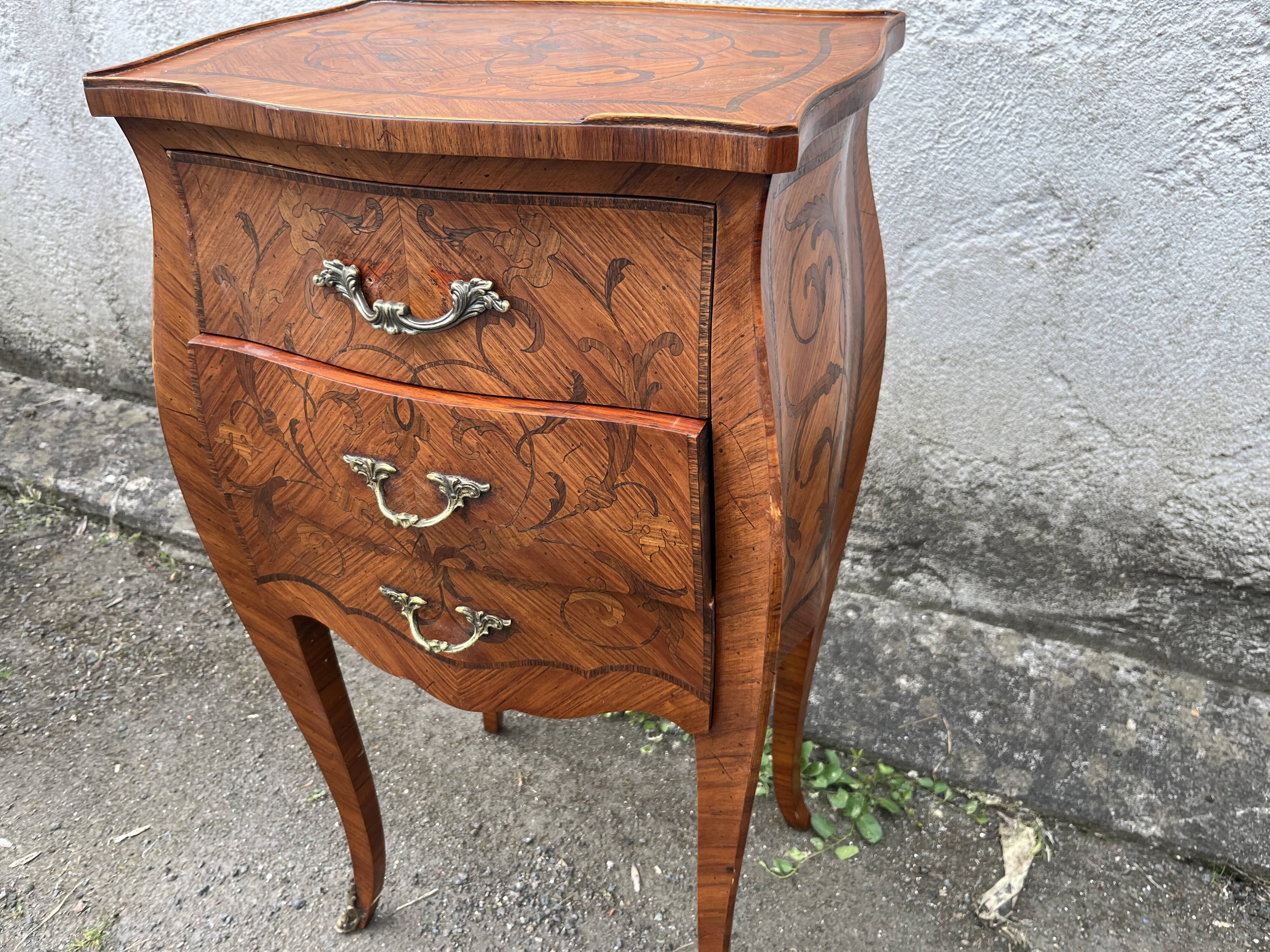 Pair of bedside tables with bombé shape, marquetry, and bronze in Louis XV style.
