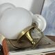 Pair of vintage wall sconces in brass with white glass globe shades.