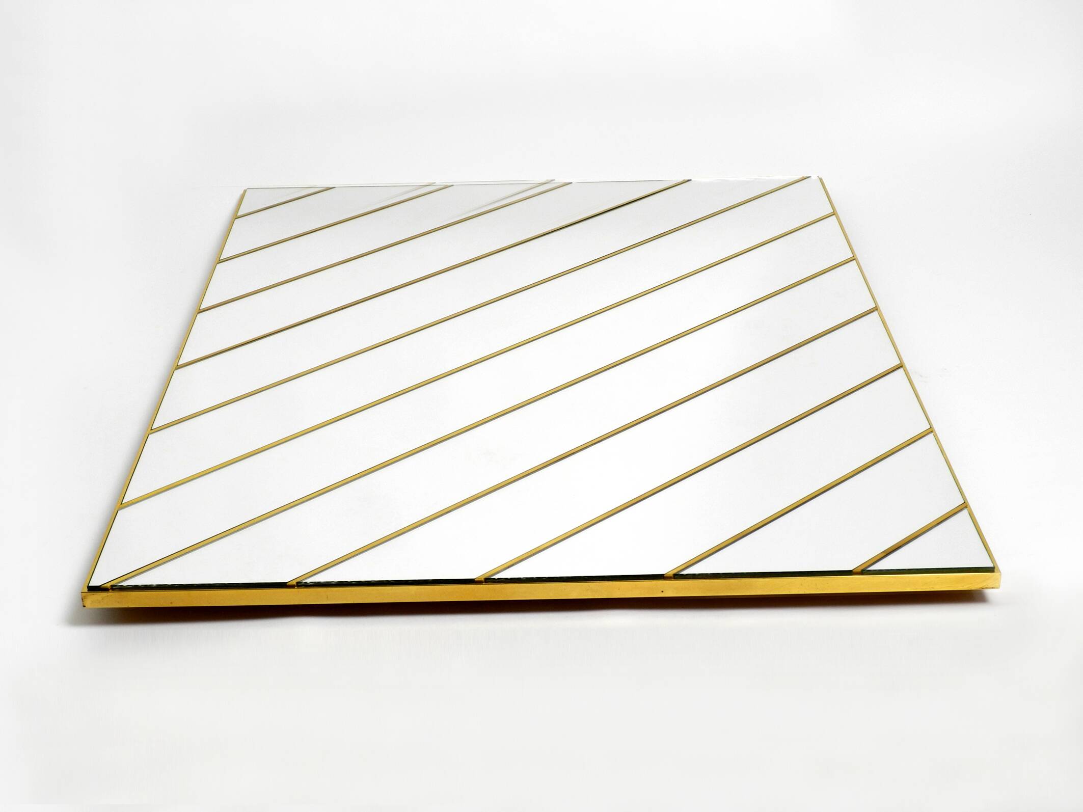 Large, exceptional 1970s brass wall mirror with diagonal mirror strips