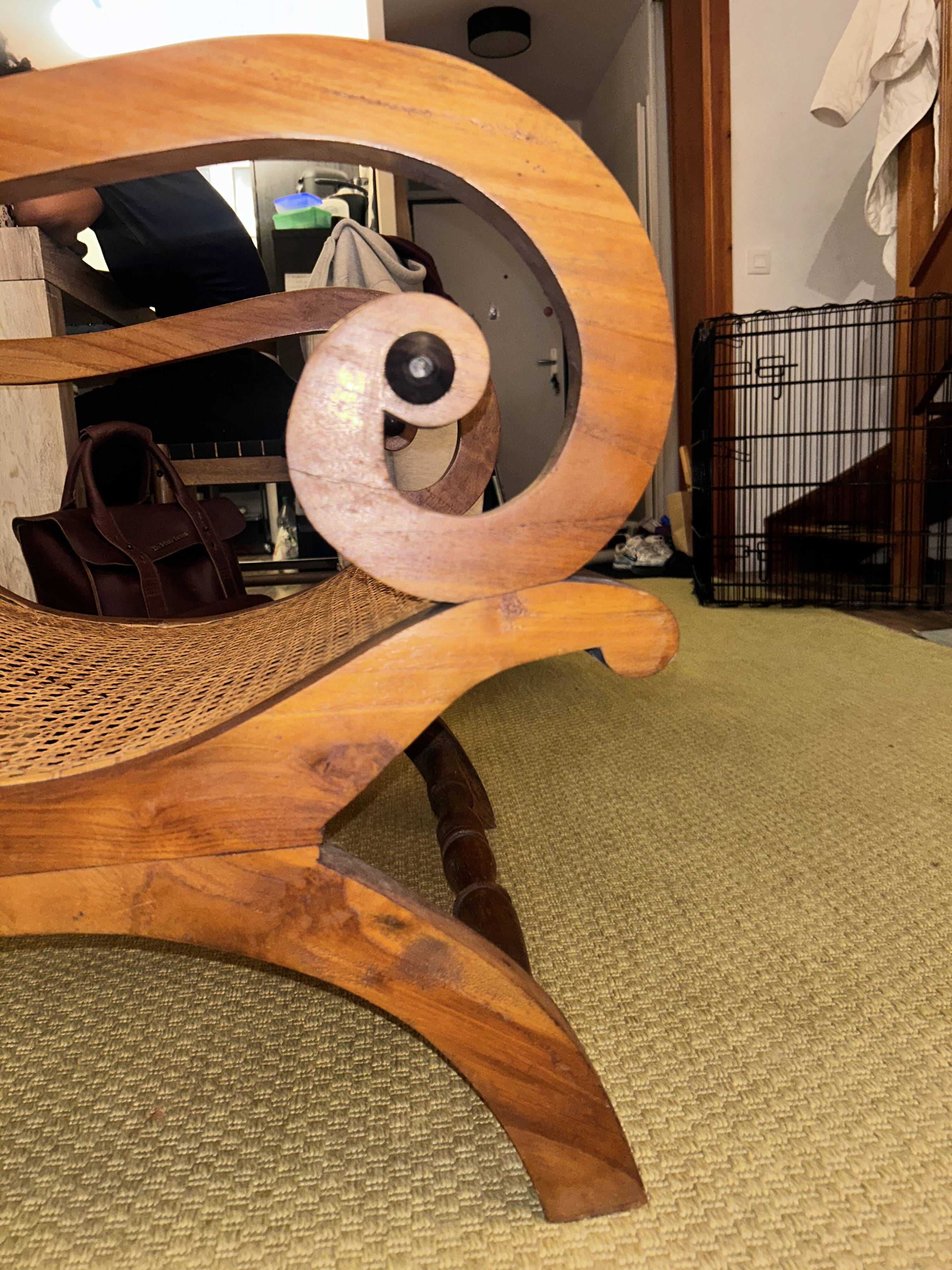 Colonial planter's armchair in solid teak, scroll armrests, caned seat.