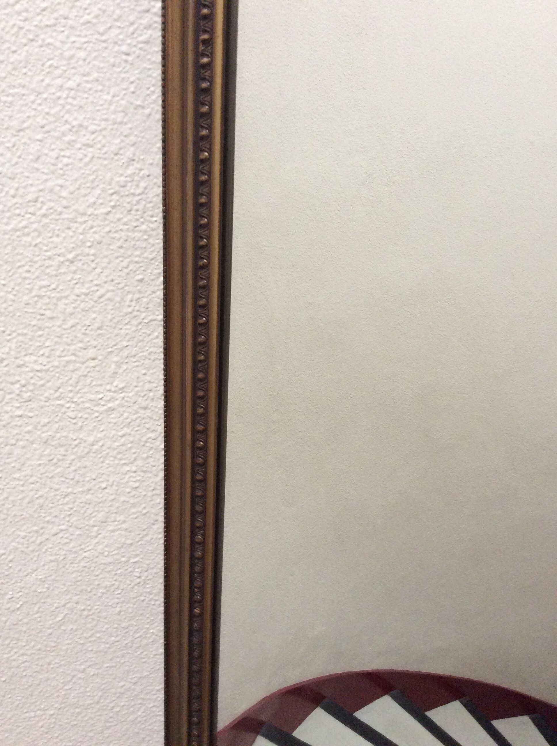 Framed mirror in bronze