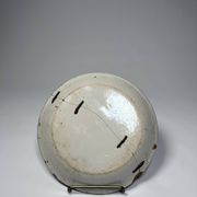 Two antique 18th-century faience plates, stapled.