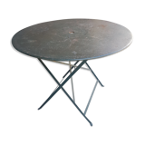 Old folding garden table in wrought iron
