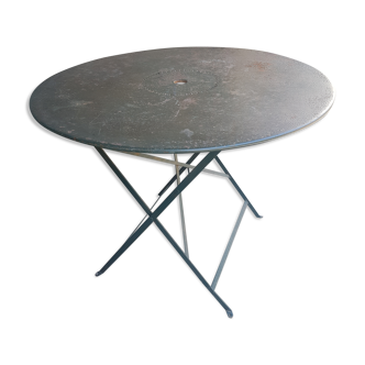 Old folding garden table in wrought iron