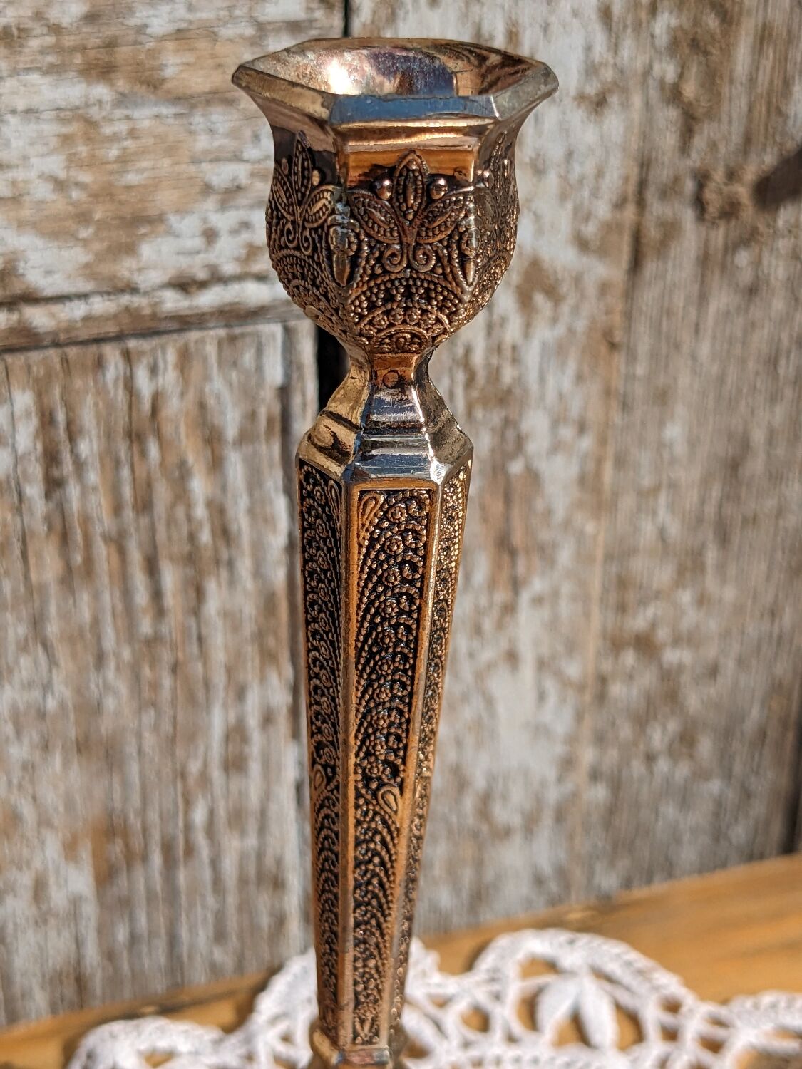 Pair of chiseled metal candle holders