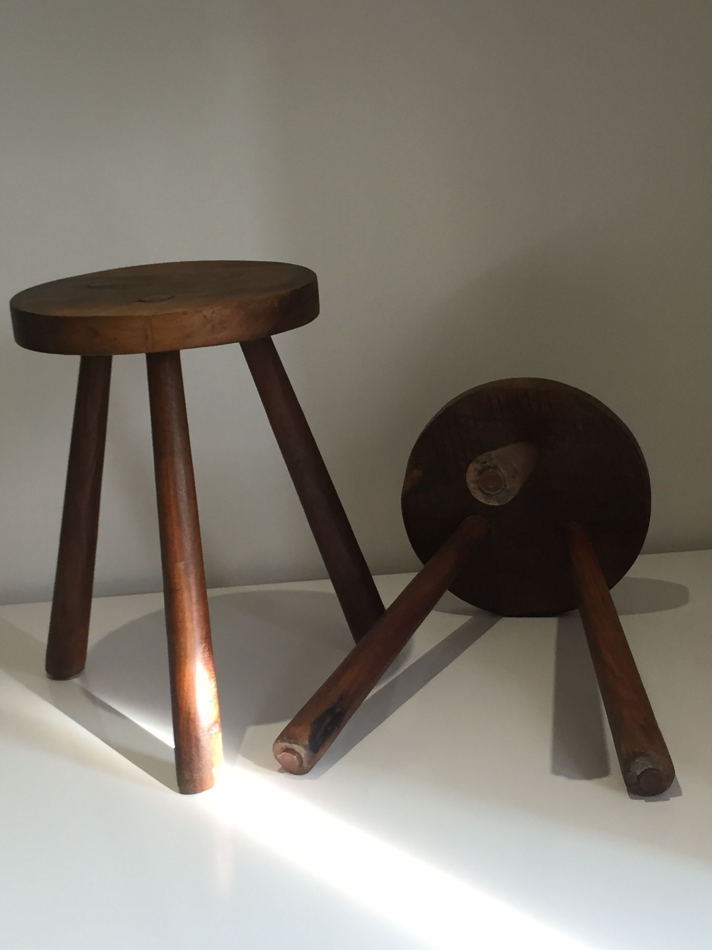 Pair of brutalist wooden tripod stools, France, 1960s