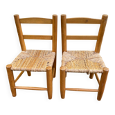 Pair of vintage children's chairs in wood and woven straw.