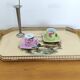 Vintage service tray with a golden gallery and mirror, decorated with ducks.