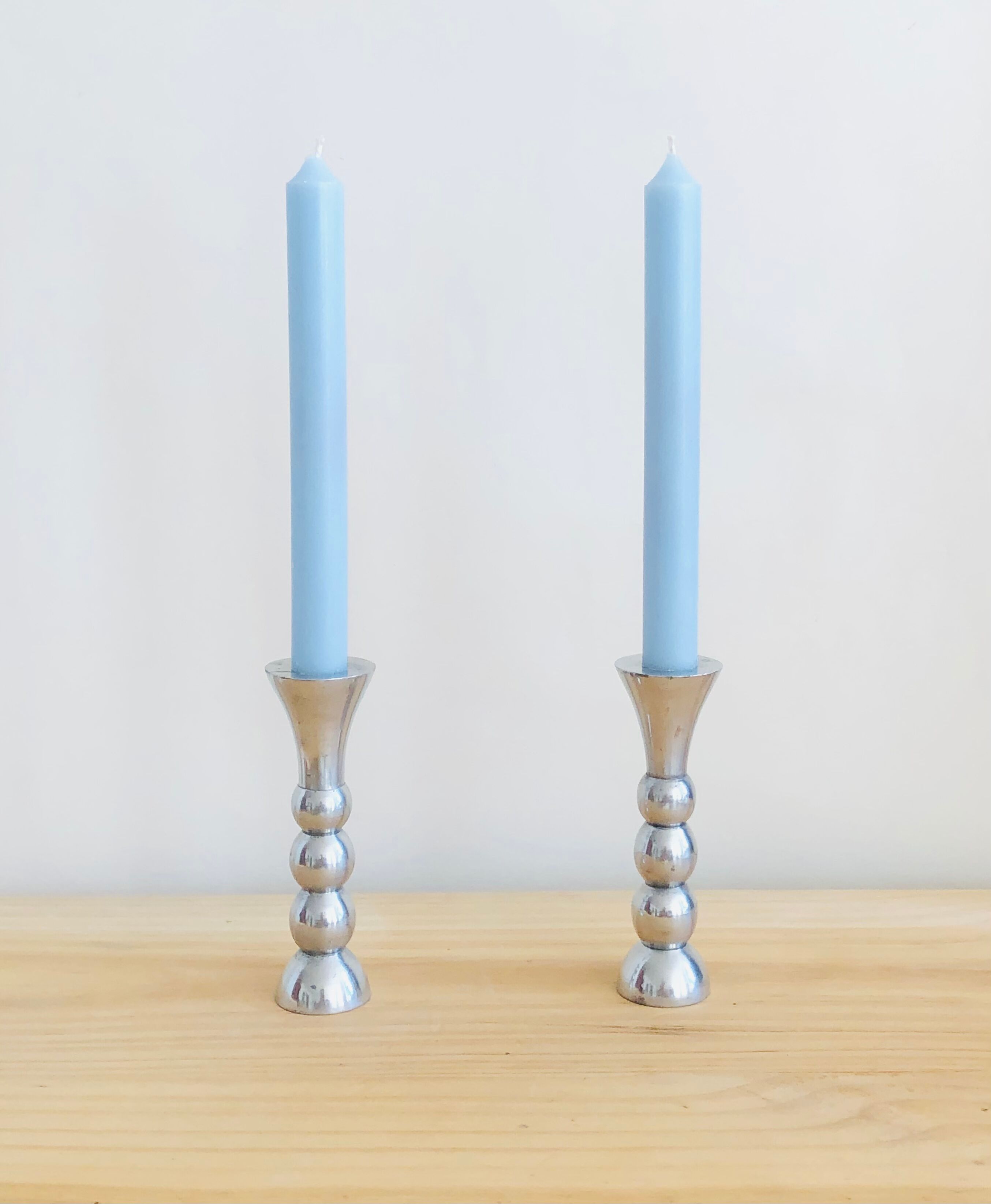Pair of vintage cast aluminum candle holders