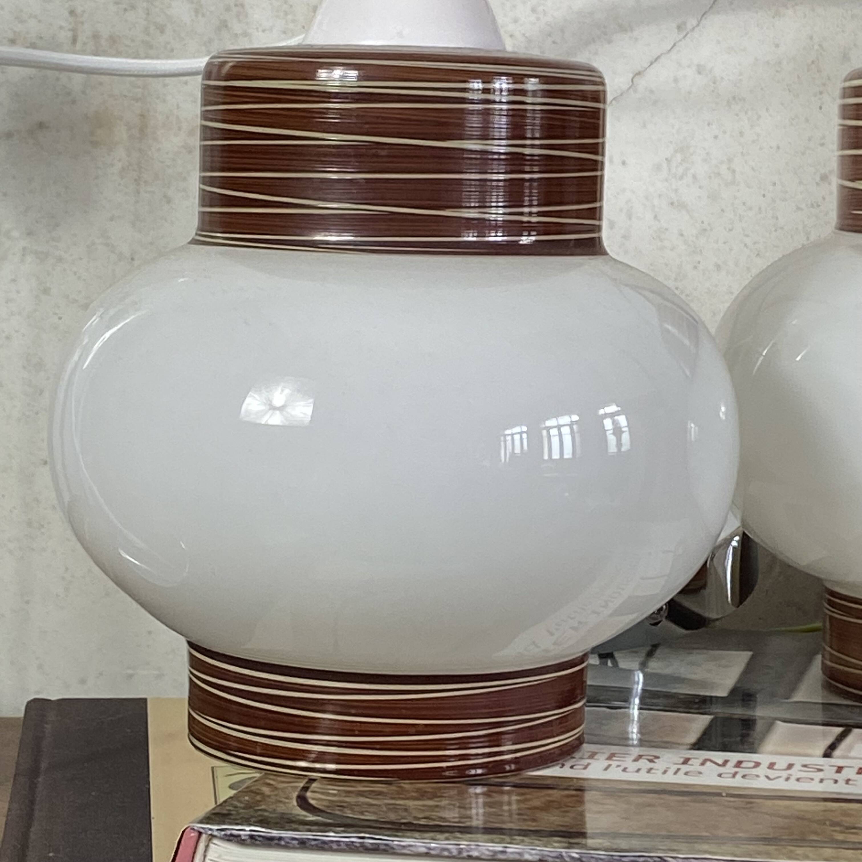Pair of pendant lights with white glass shades from the 1950s.