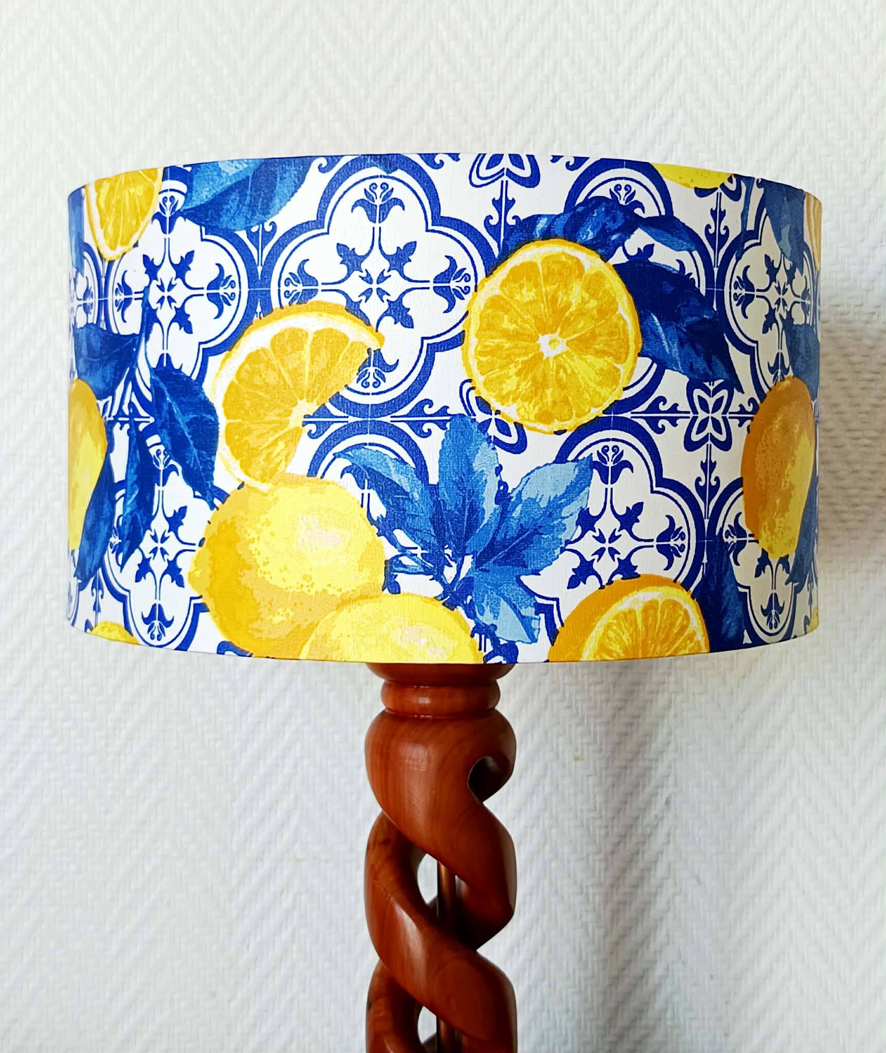 Turned wooden lamp with a lampshade featuring lemon tiles.
