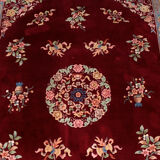 China wool fringed rug with floral pattern on deep plum background 393x274cm