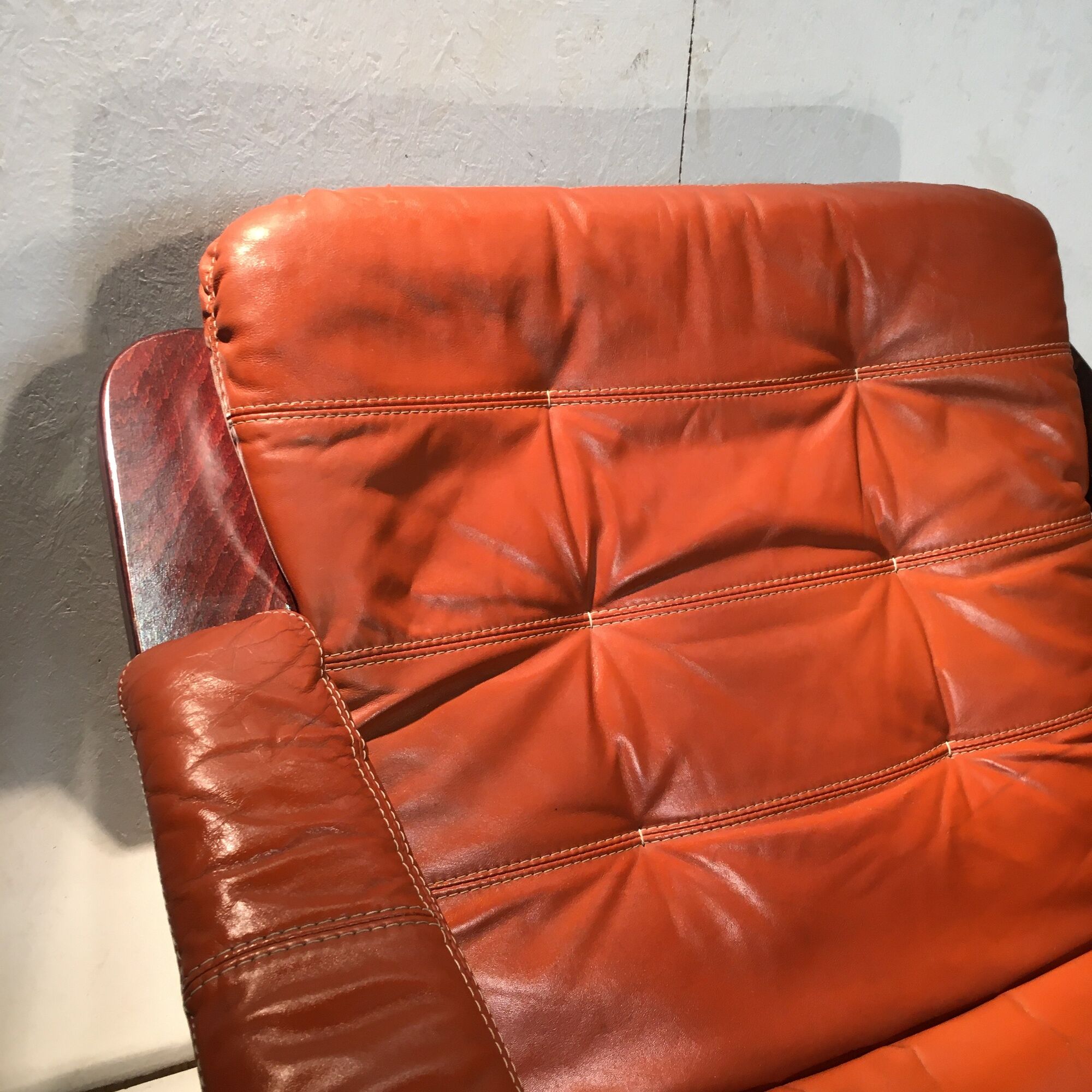 Duo of ochre leather and wood frame armchairs