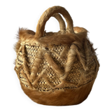 Handwoven vintage basket with handles made from natural fibres.