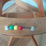 Baumann Baby Coquille children's armchair in bent wood with splayed legs.