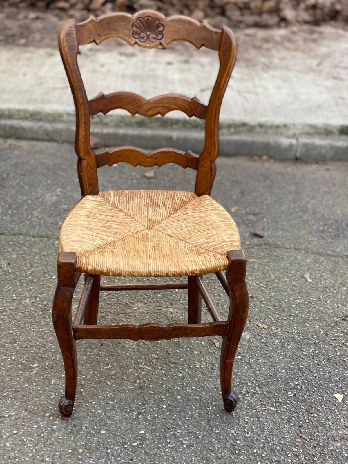 Louis XV 18th century solid wood dining chair with a straw seat.
