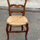 Louis XV 18th century solid wood dining chair with a straw seat.