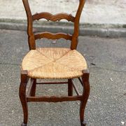 Louis XV 18th century solid wood dining chair with a straw seat.