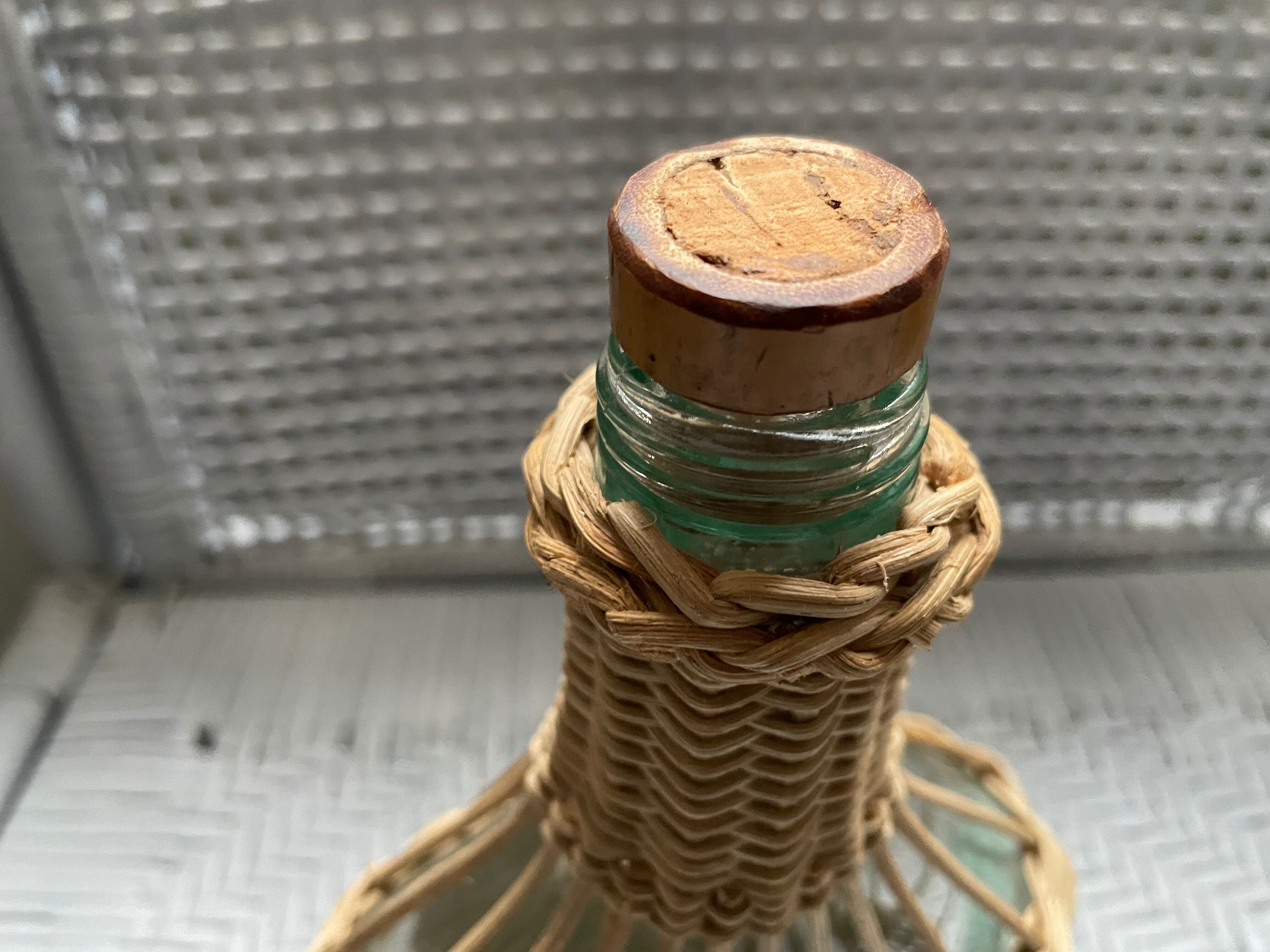 Wicker-sheathed glass bottle