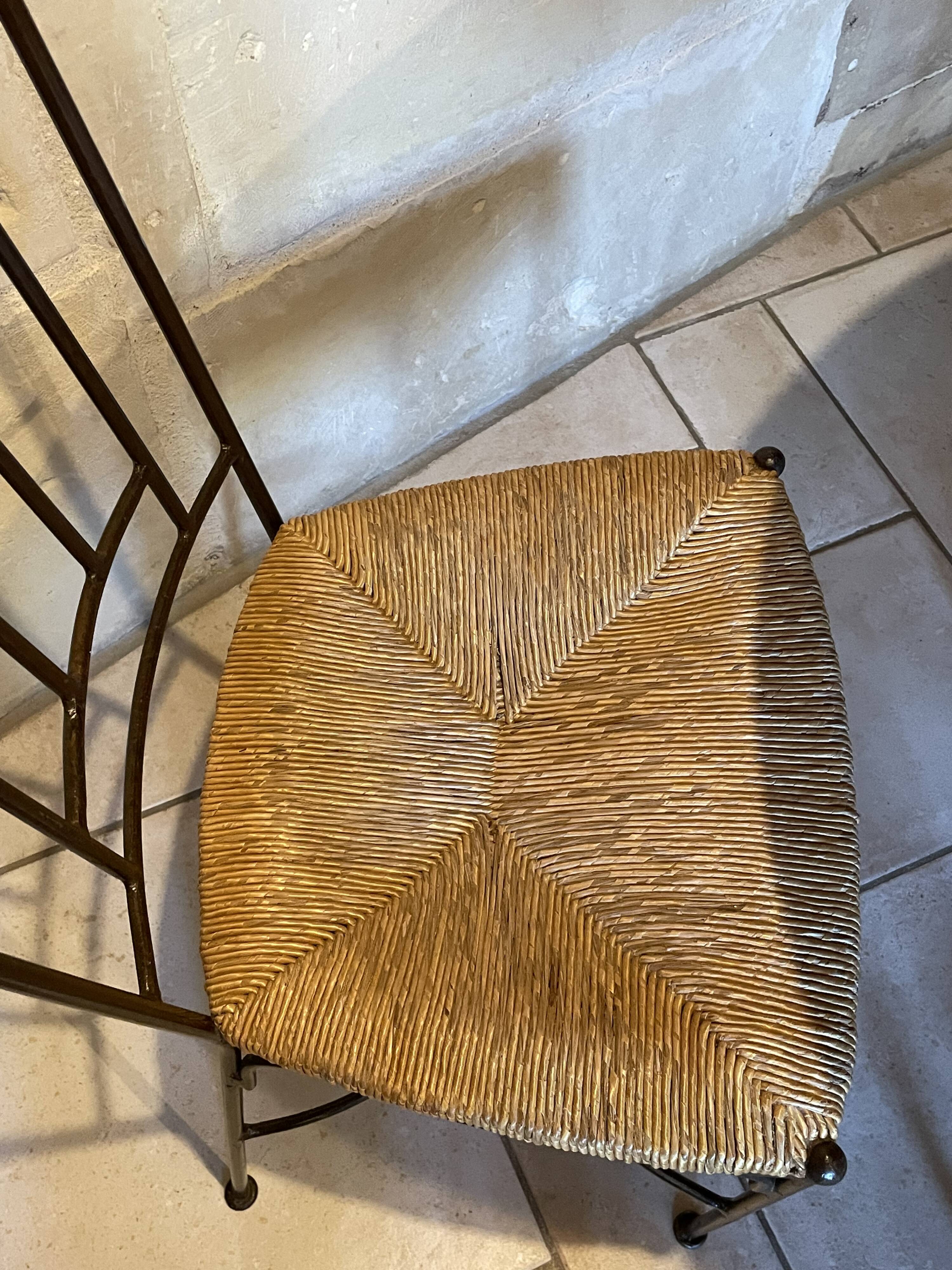 Table and four wrought iron and wood chairs.