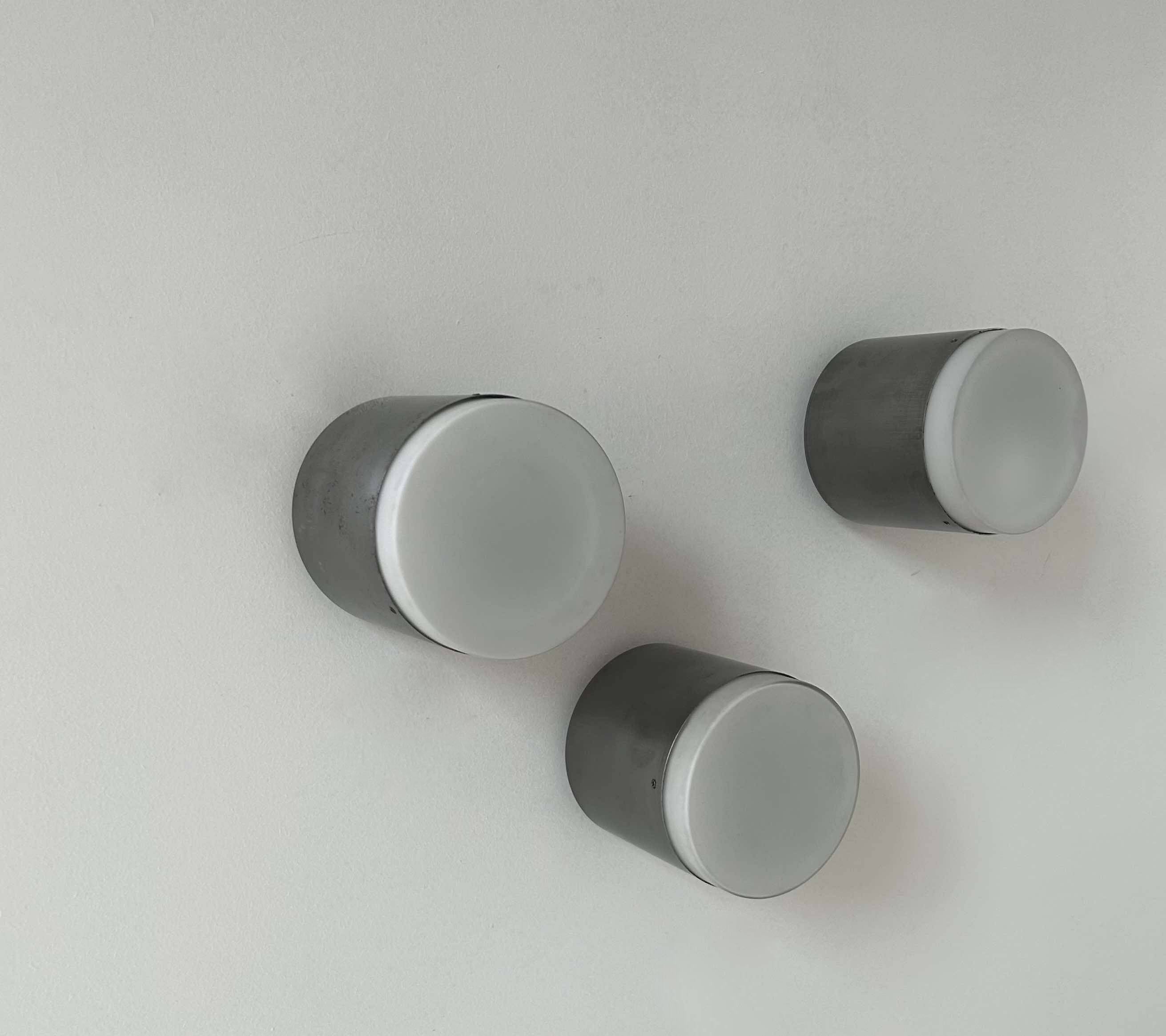 Set of 3 vintage Raak wall lights, aluminum and opaline, Holland 1960