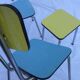 Two chairs and a yellow and blue stool in formica