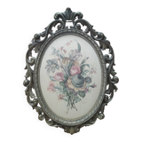 Golden brass frame with bouquet of flowers on silky fabric