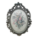 Golden brass frame with bouquet of flowers on silky fabric