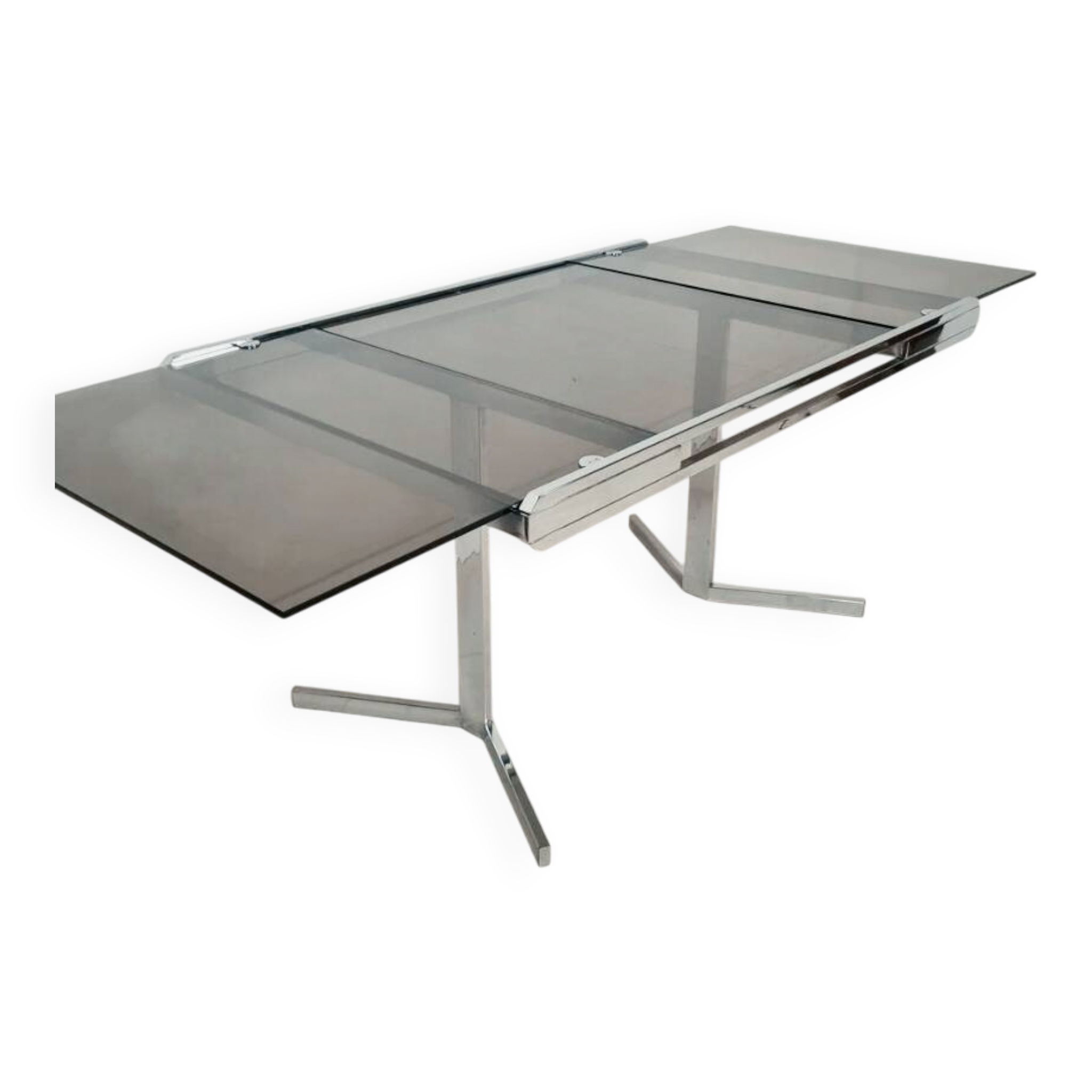 Table pietement chromé et verre fumé année 70 avec allonges