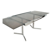 Table pietement chromé et verre fumé année 70 avec allonges