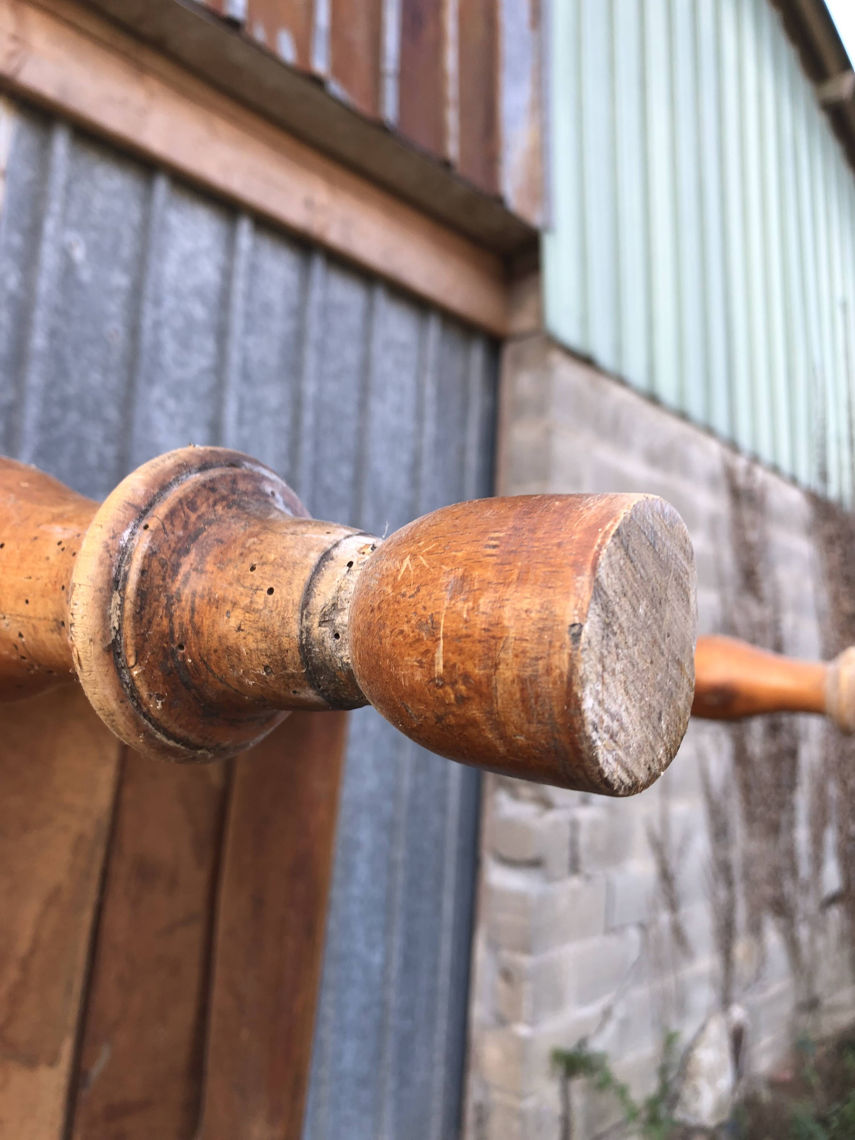 Antique farmhouse table in solid cherry wood with turned legs.