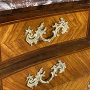 Louis XV style commode in rosewood and palisander veneer, gilt bronze mounts, and Rance marble top.