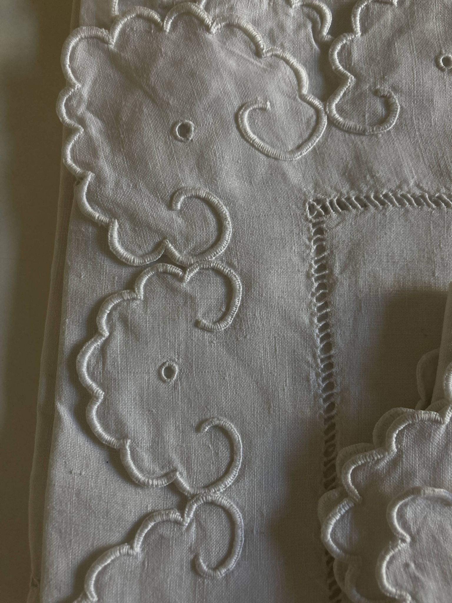 Pair of 19th-century linen pillowcases embroidered with scallops.