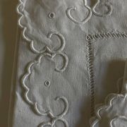 Pair of 19th-century linen pillowcases embroidered with scallops.