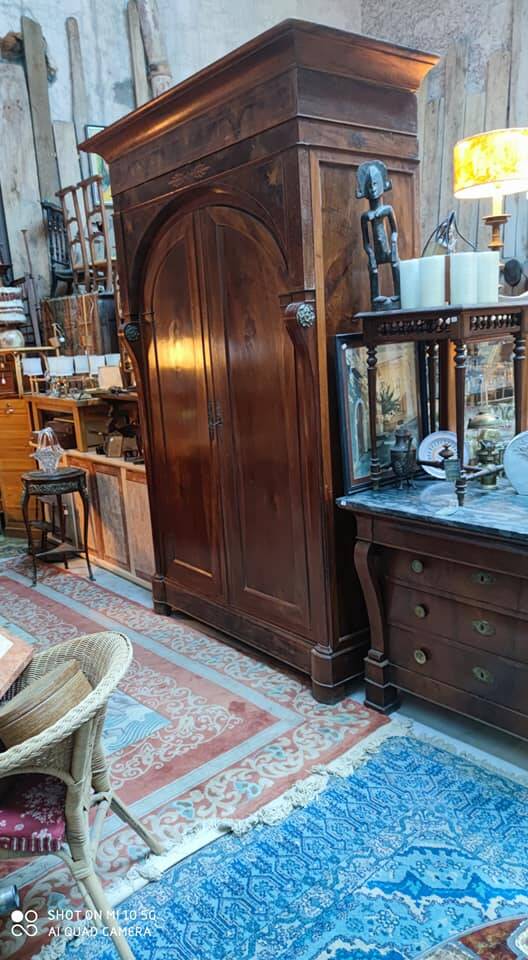 A walnut wardrobe with marquetry and boxwood stringing, dating from the Consulate period, circa 1810.