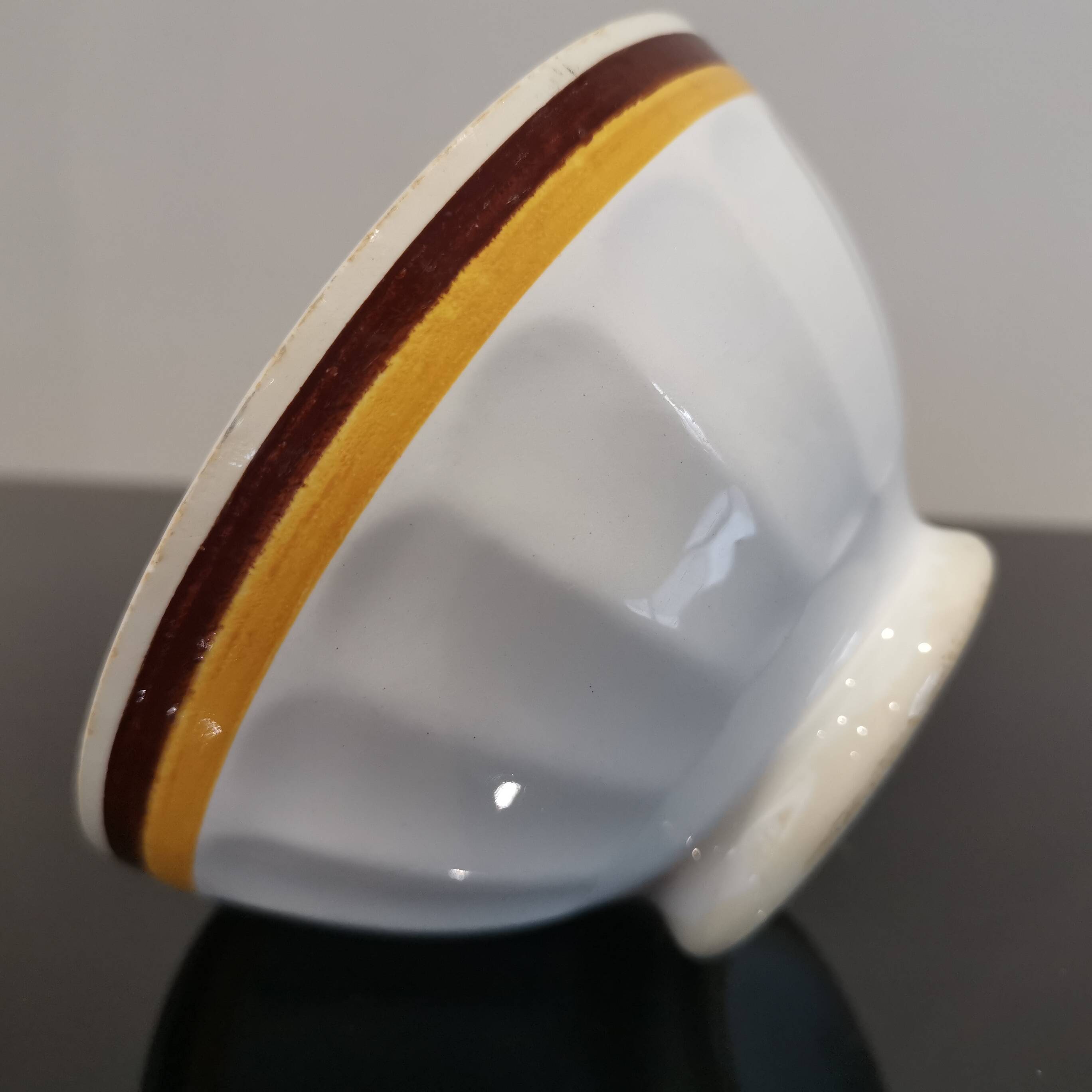 Authentic Vintage ceramic faceted bowl decorated with a double border