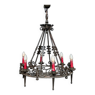 Wrought chandelier in Gothic style.