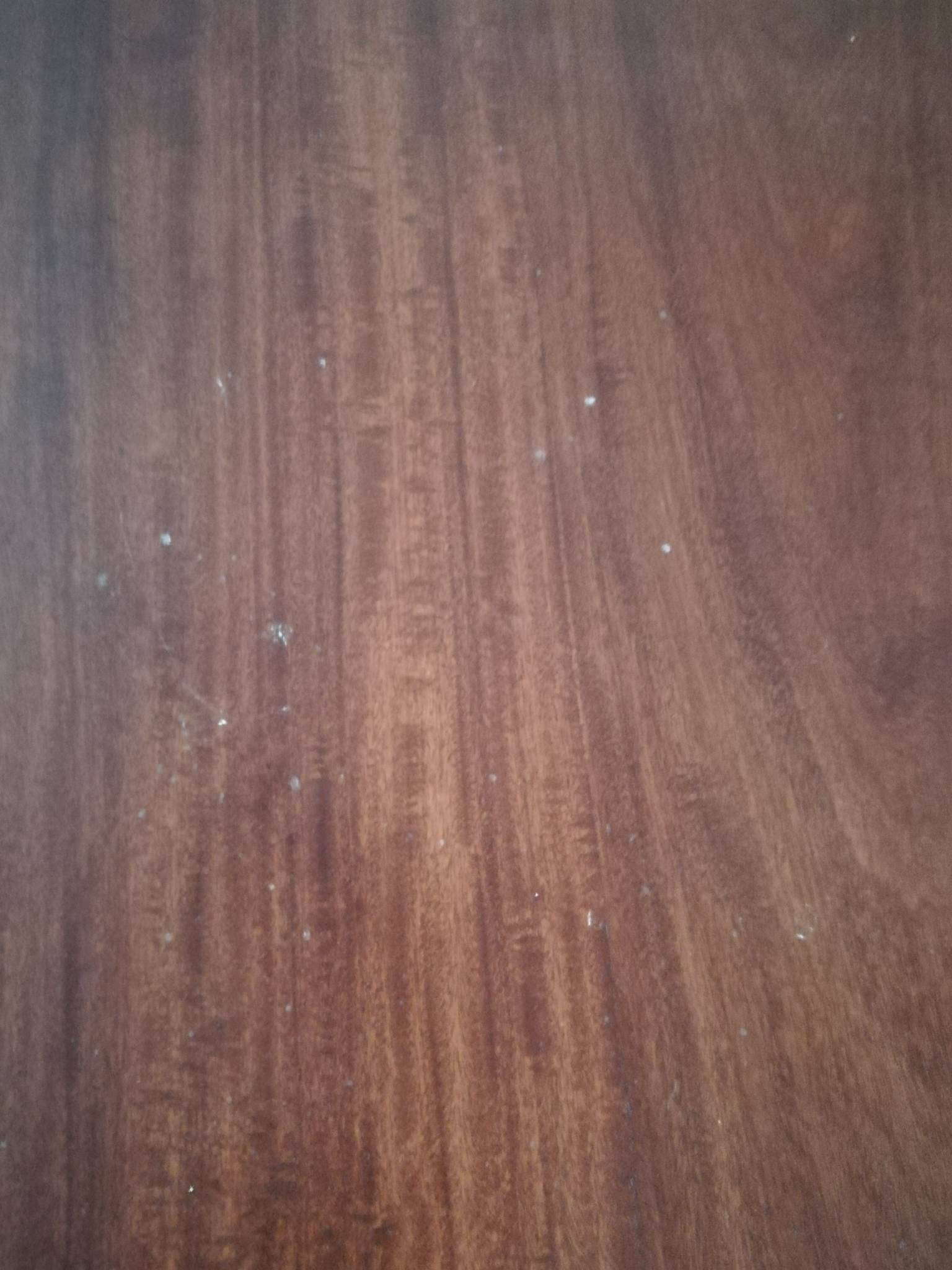 Round wooden table with thin legs